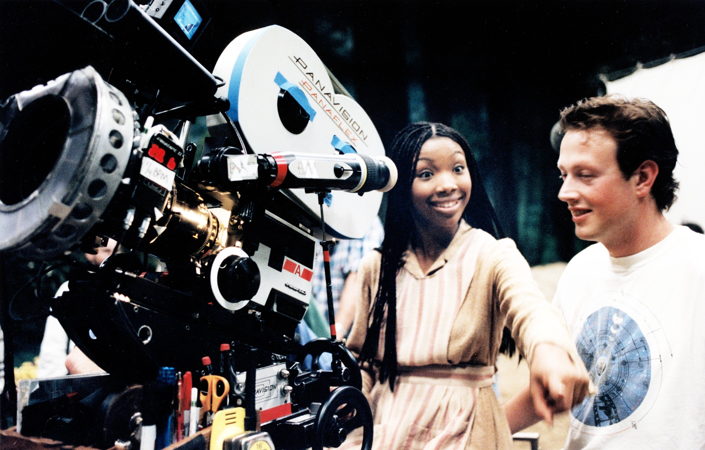 Brandy holds a large camera on set