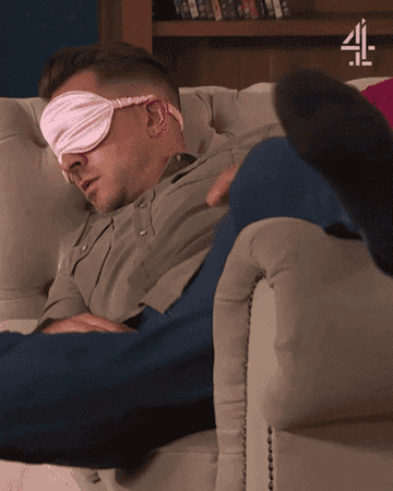 GIF of Hollyoaks character sleeping with an eye mask and then abruptly taking it off after being woken up