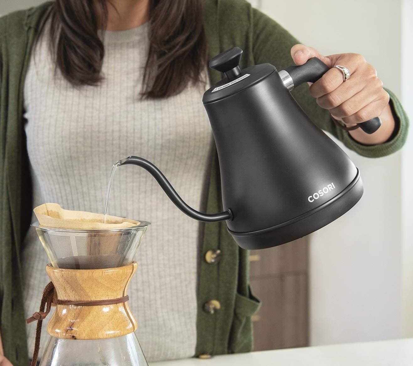 someone using the gooseneck kettle to make pour-over coffee
