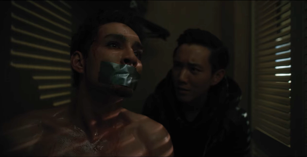 Klaus with tape over his mouth and Ben behind him