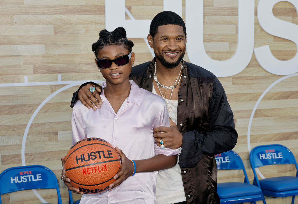Naviyd and Usher posing with a basketball