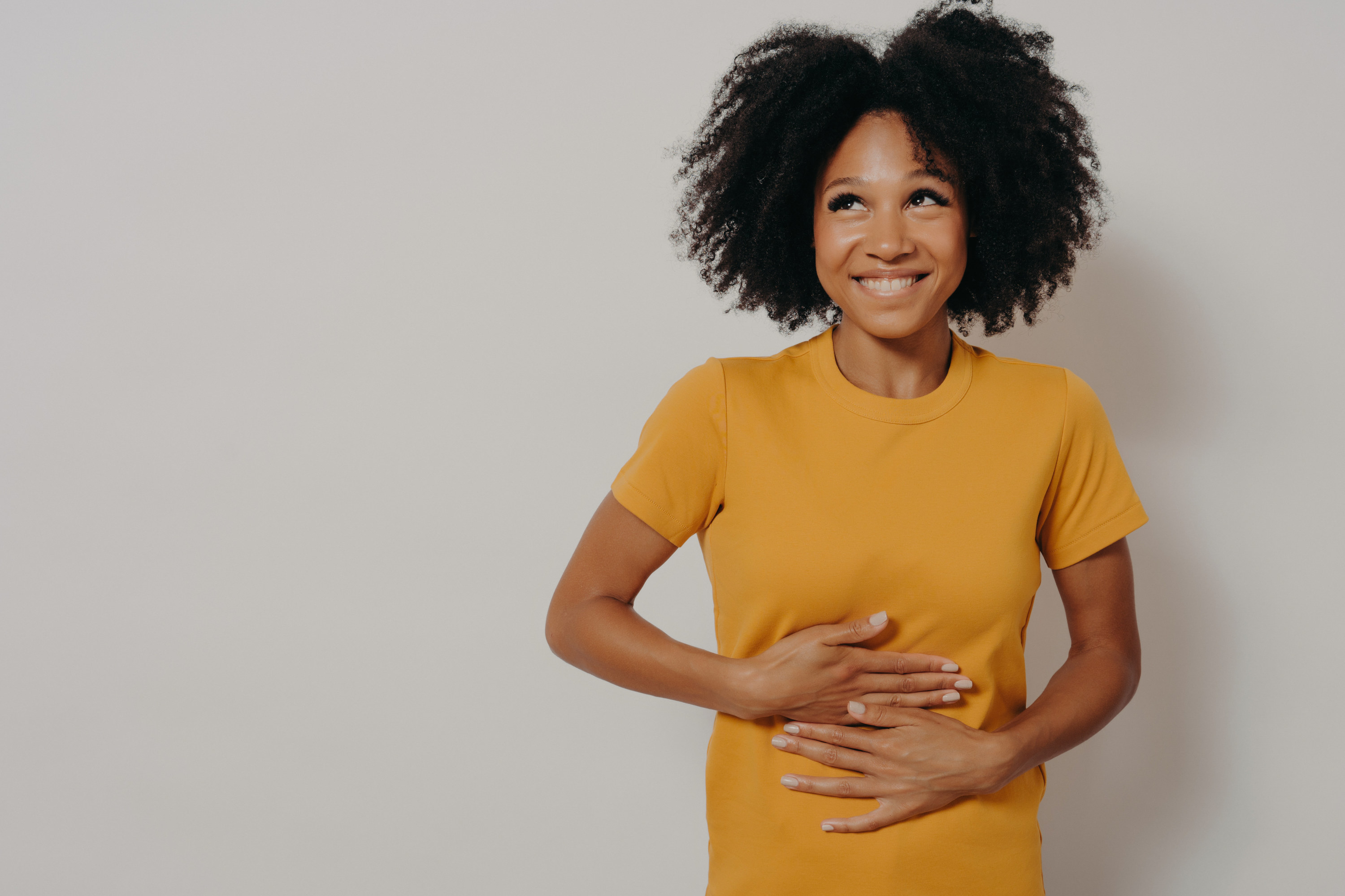 A woman holding her tummy