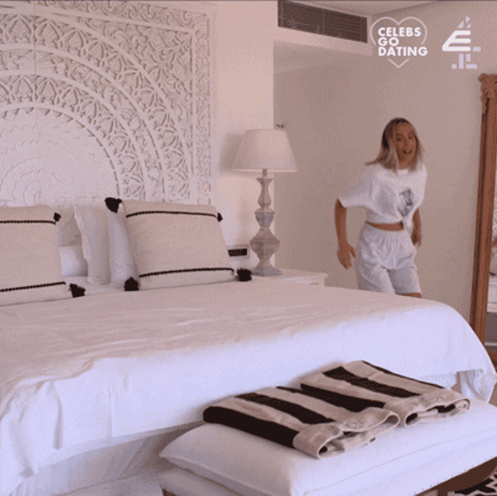 person jumping on a bed