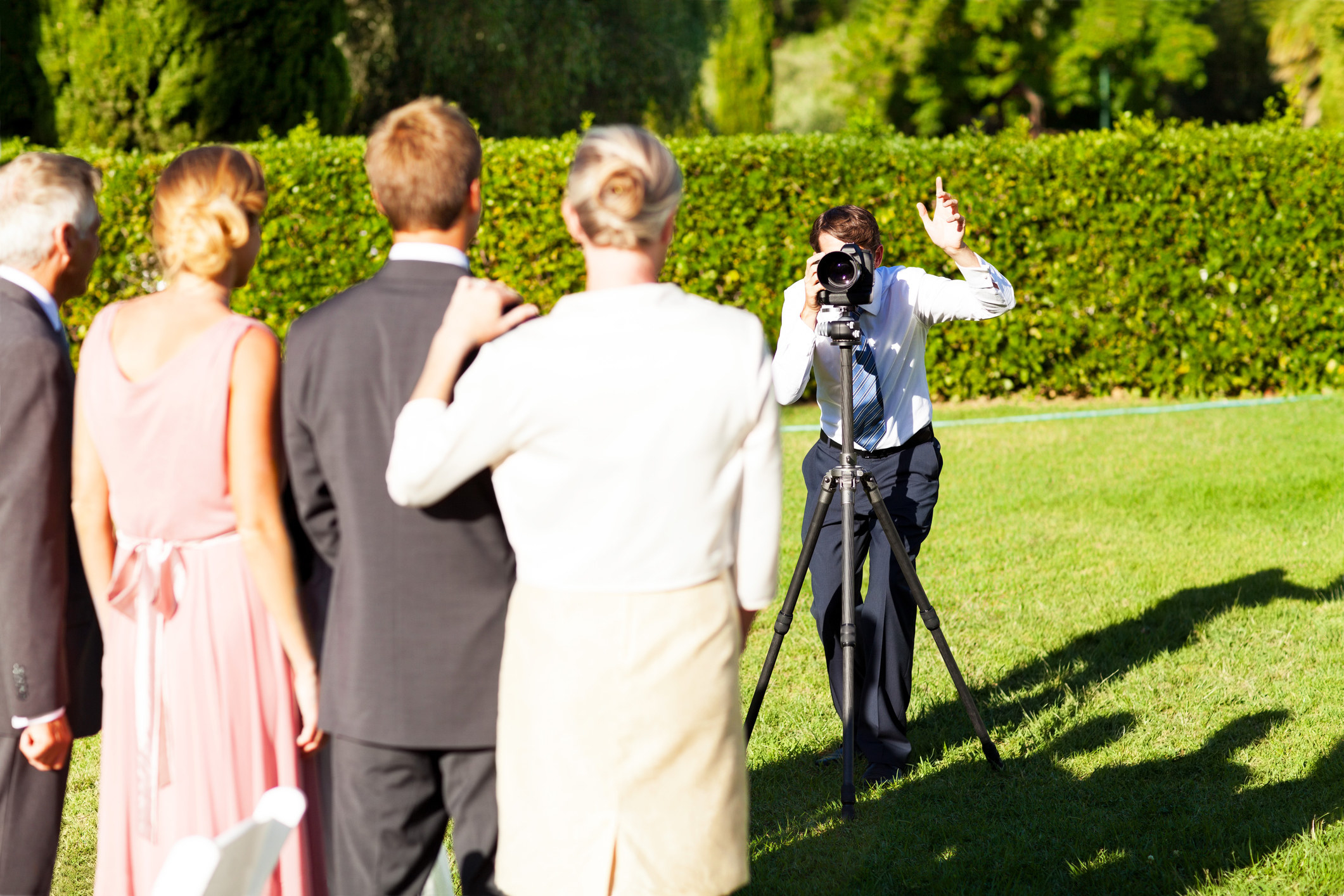 a photographer taking a photo of the wedding family