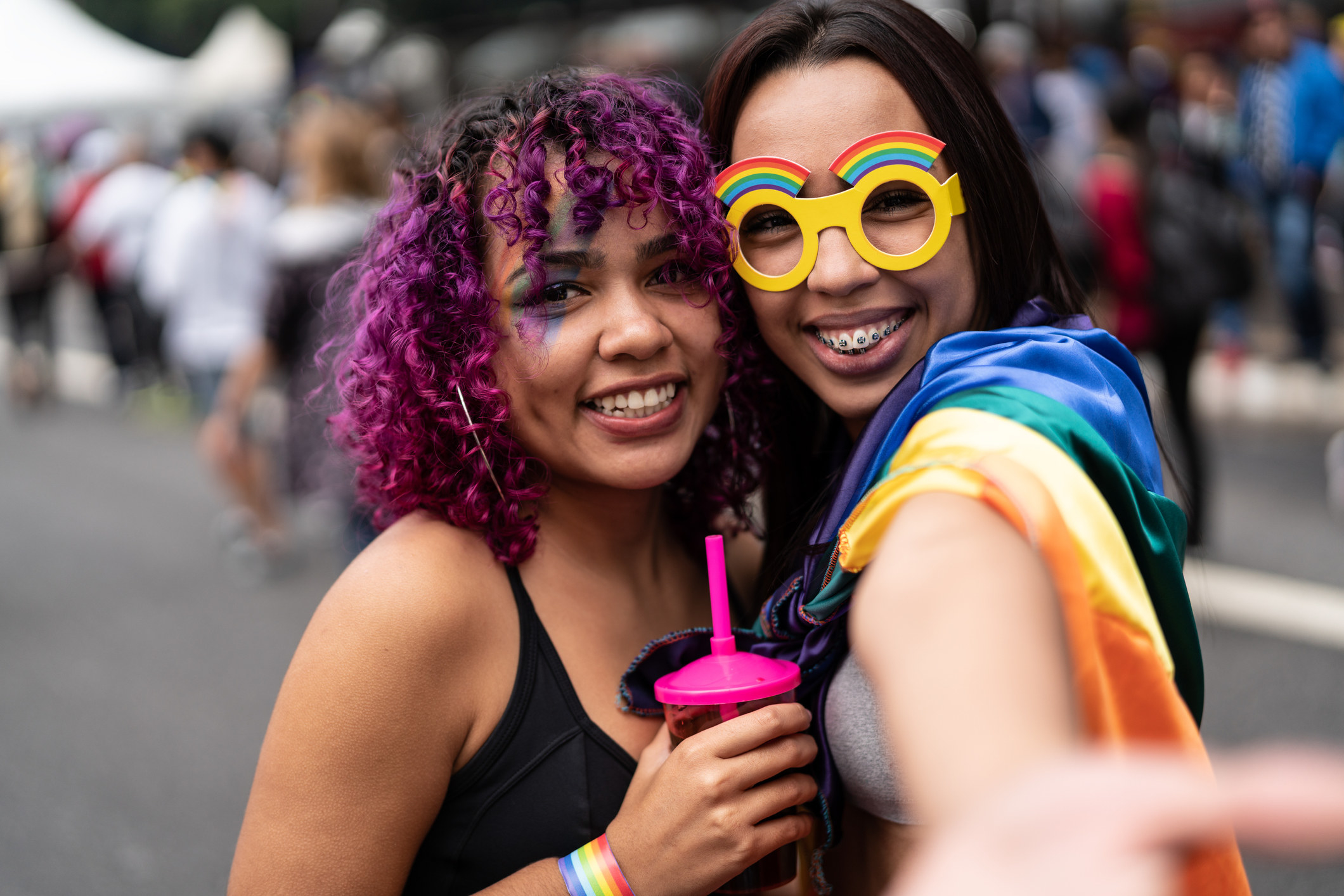 two people pose for a picture during pride parade