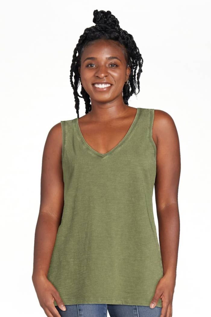 A model wearing a green top with jeans