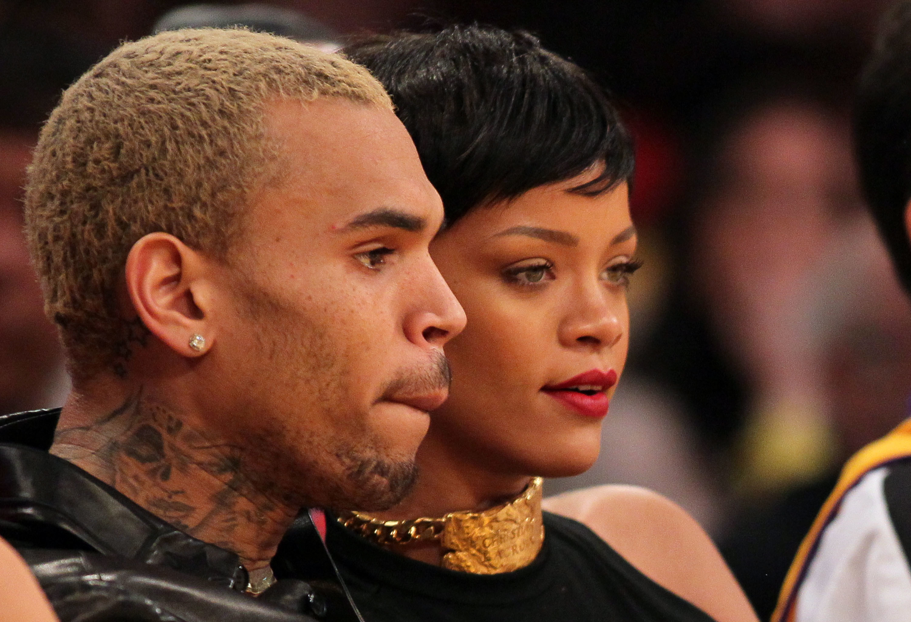 Chris Brown and Rihanna attend the NBA game between the New York Knicks and the Los Angeles Lakers at Staples Center on December 25, 2012