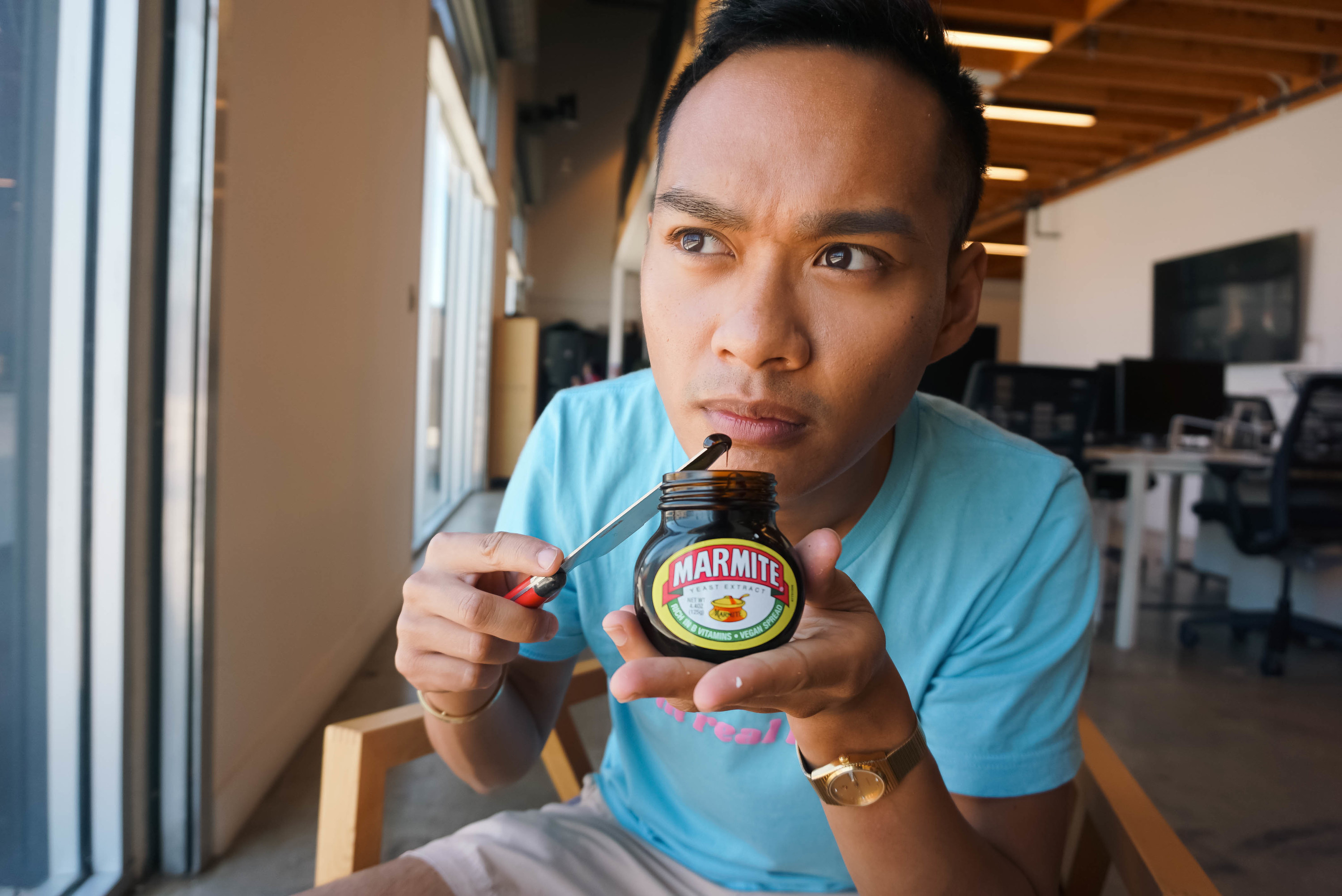 author smelling an open jar of Marmite