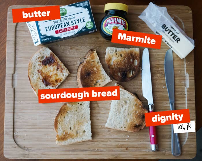 butter, marmite, and toasted bread on a wooden cutting board