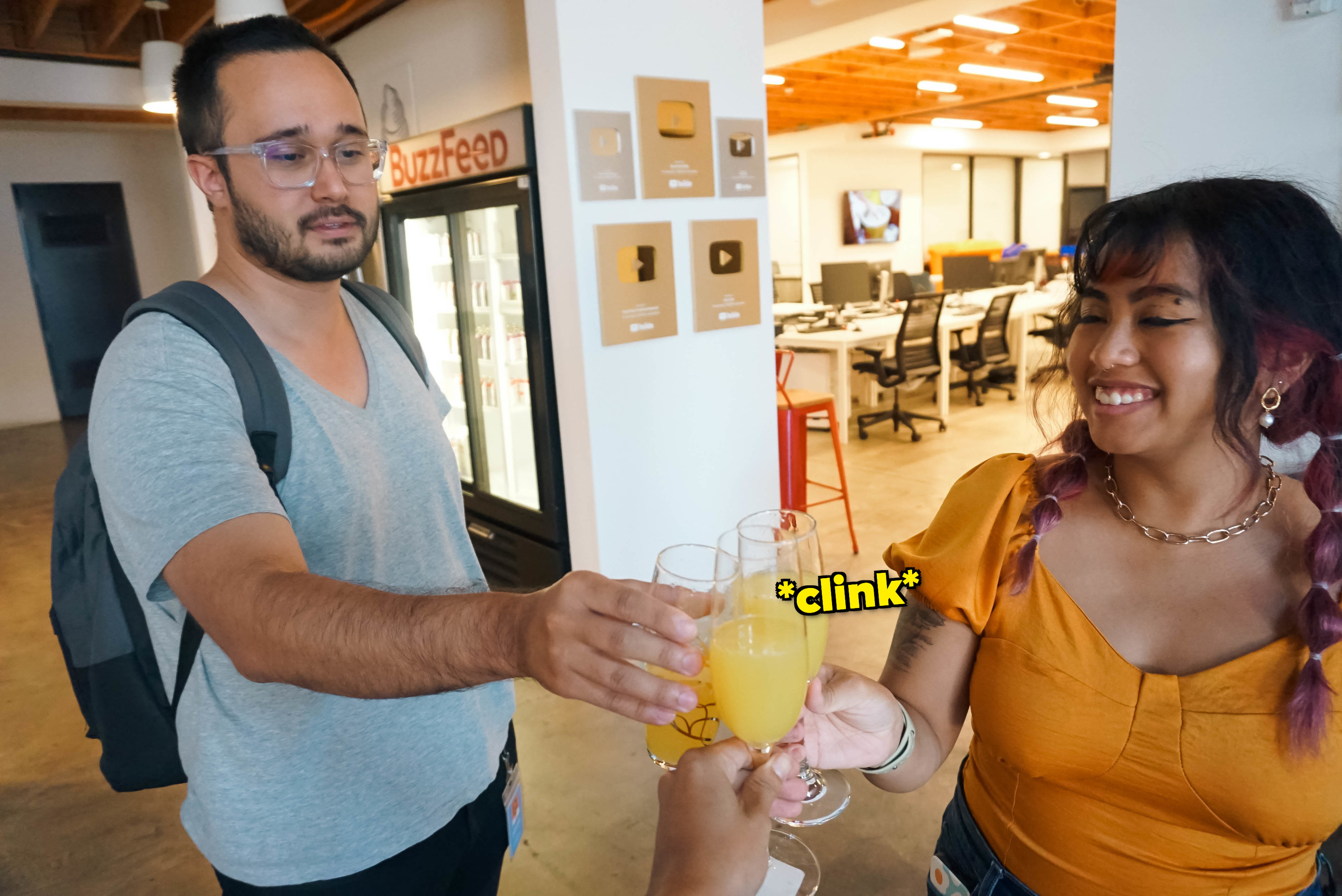 co-workers clinking champagne glasses