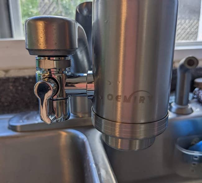 a reviewer photo of the filter attached to a sink faucet