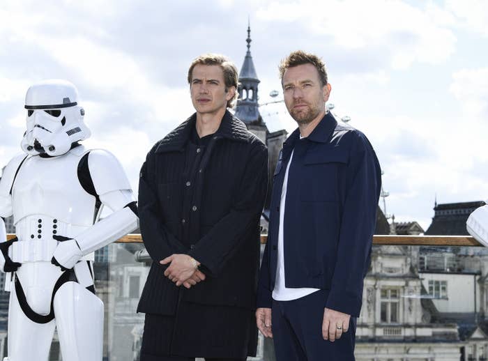 Ewan and Hayden posing together next to a stormtrooper at an Obi-Wan Kenobi event