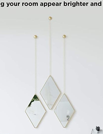 The three diamond mirrors hanging from chains on the wall