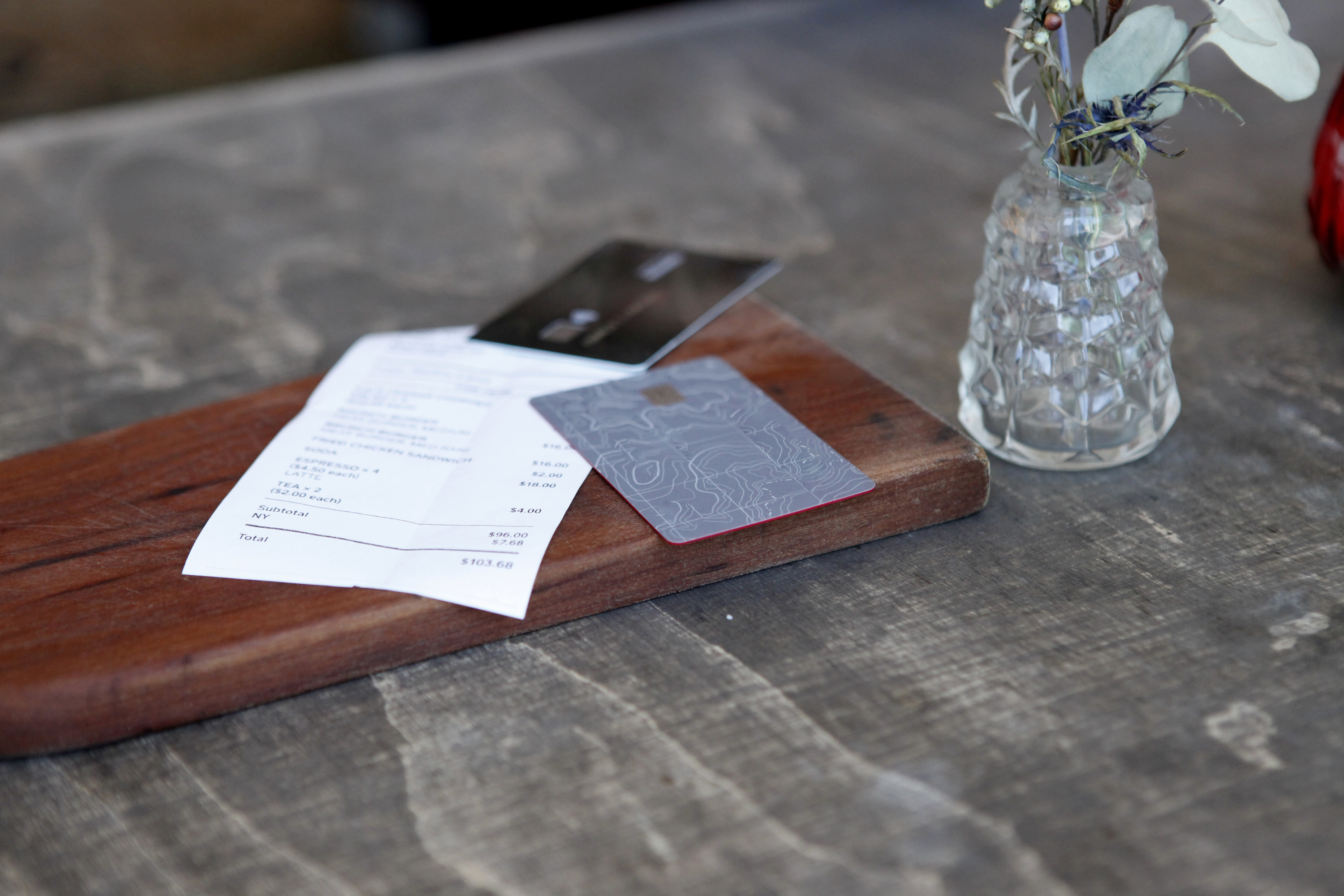 An invoice and a credit card on a table