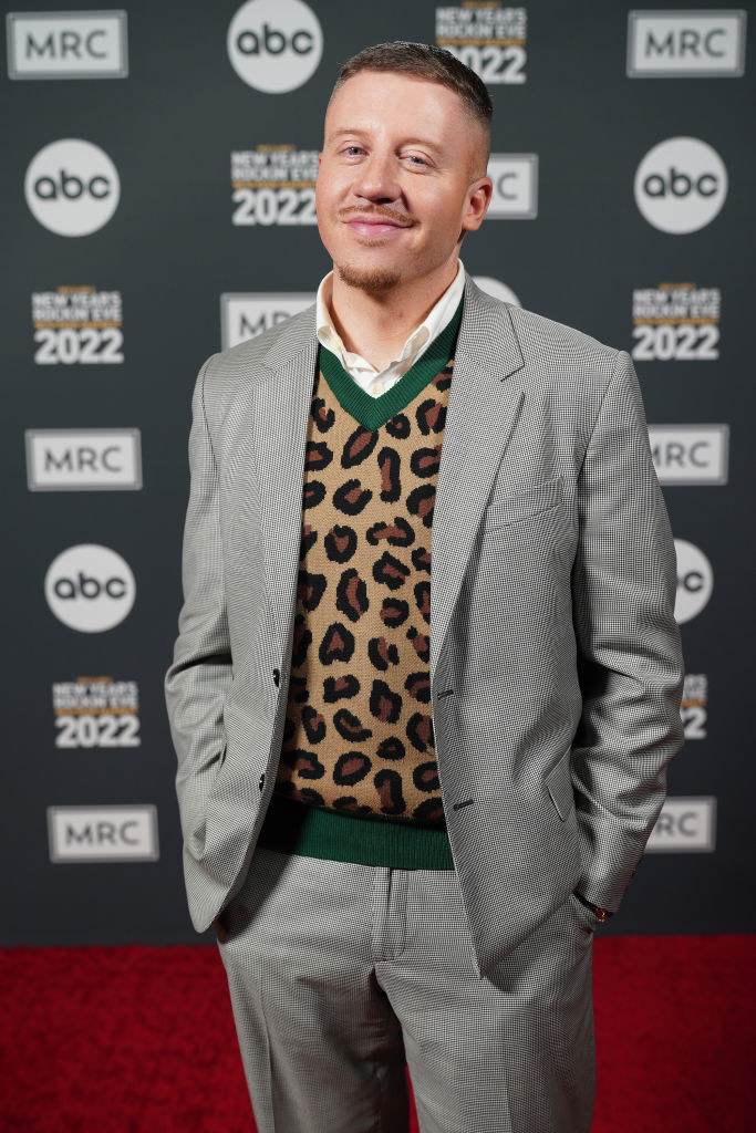 Macklemore in a suit and animal-print sweater on the red carpet