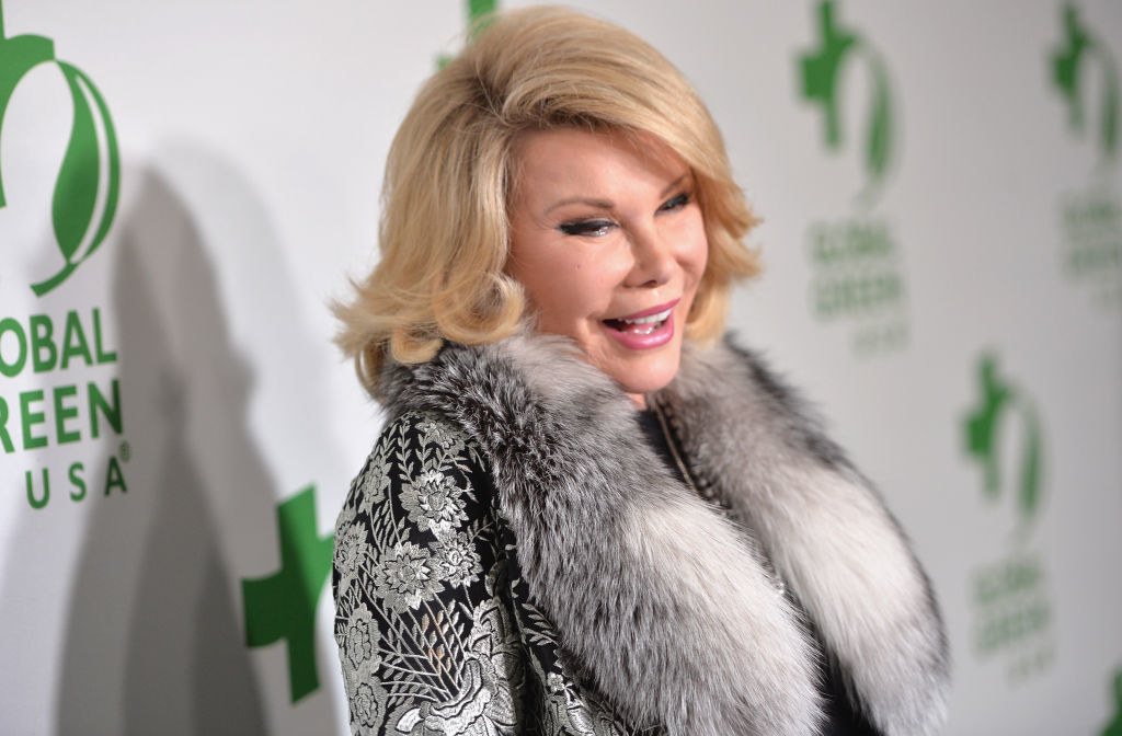 Joan in a fur-collared outfit on the red carpet