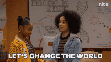 Two girls dancing in a classroom and one saying, &quot;Let&#x27;s change the world&quot;