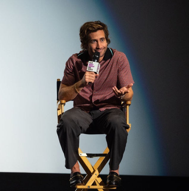 Jake sitting in a chair and holding a microphone