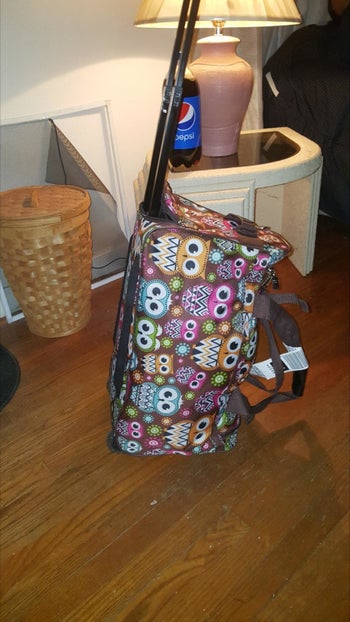 reviewer's photo of the duffel bag in owl print