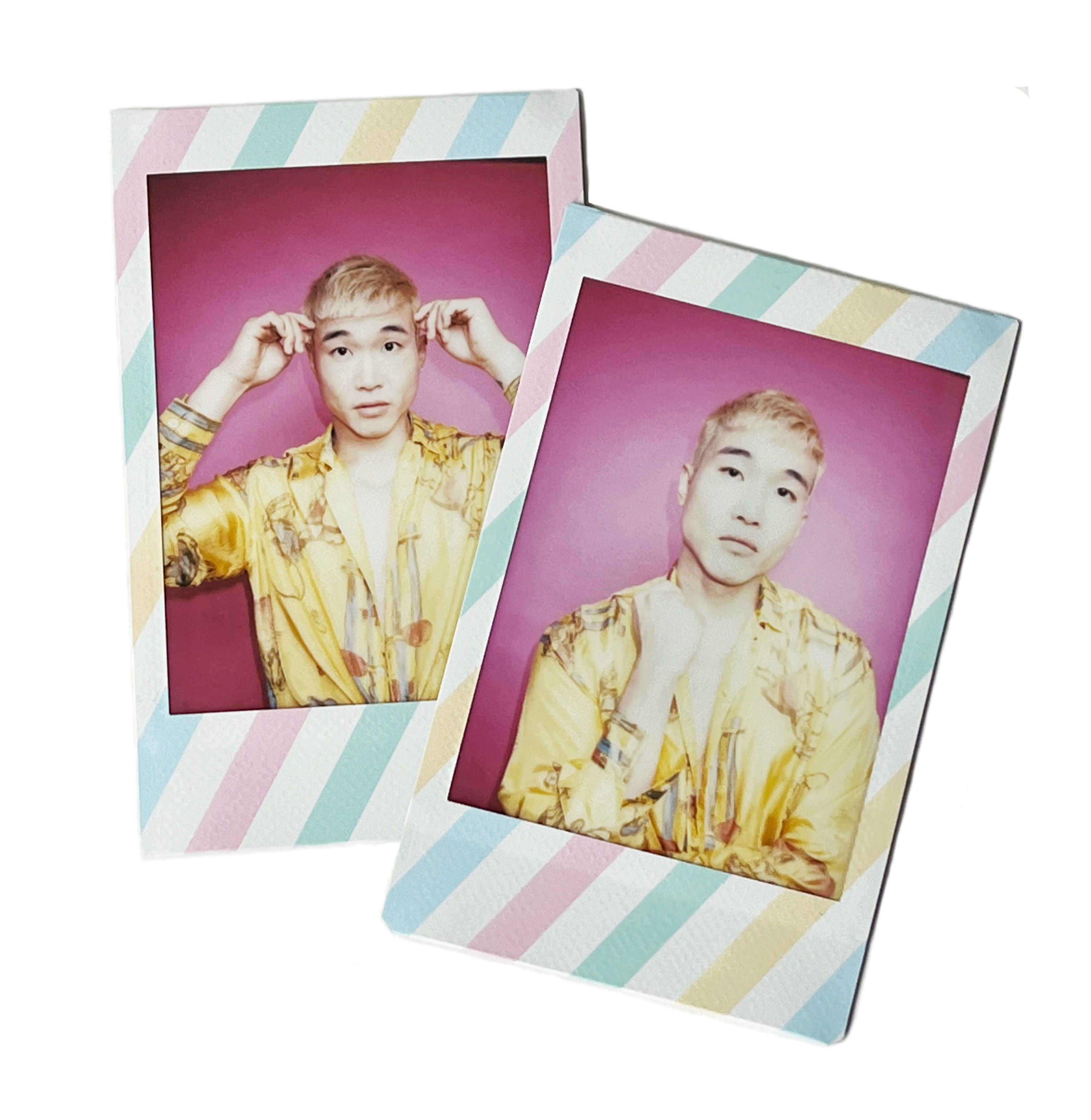 Two printed Polaroid photographs show Joel making two poses, holding fingers to his temples and holding up a fist