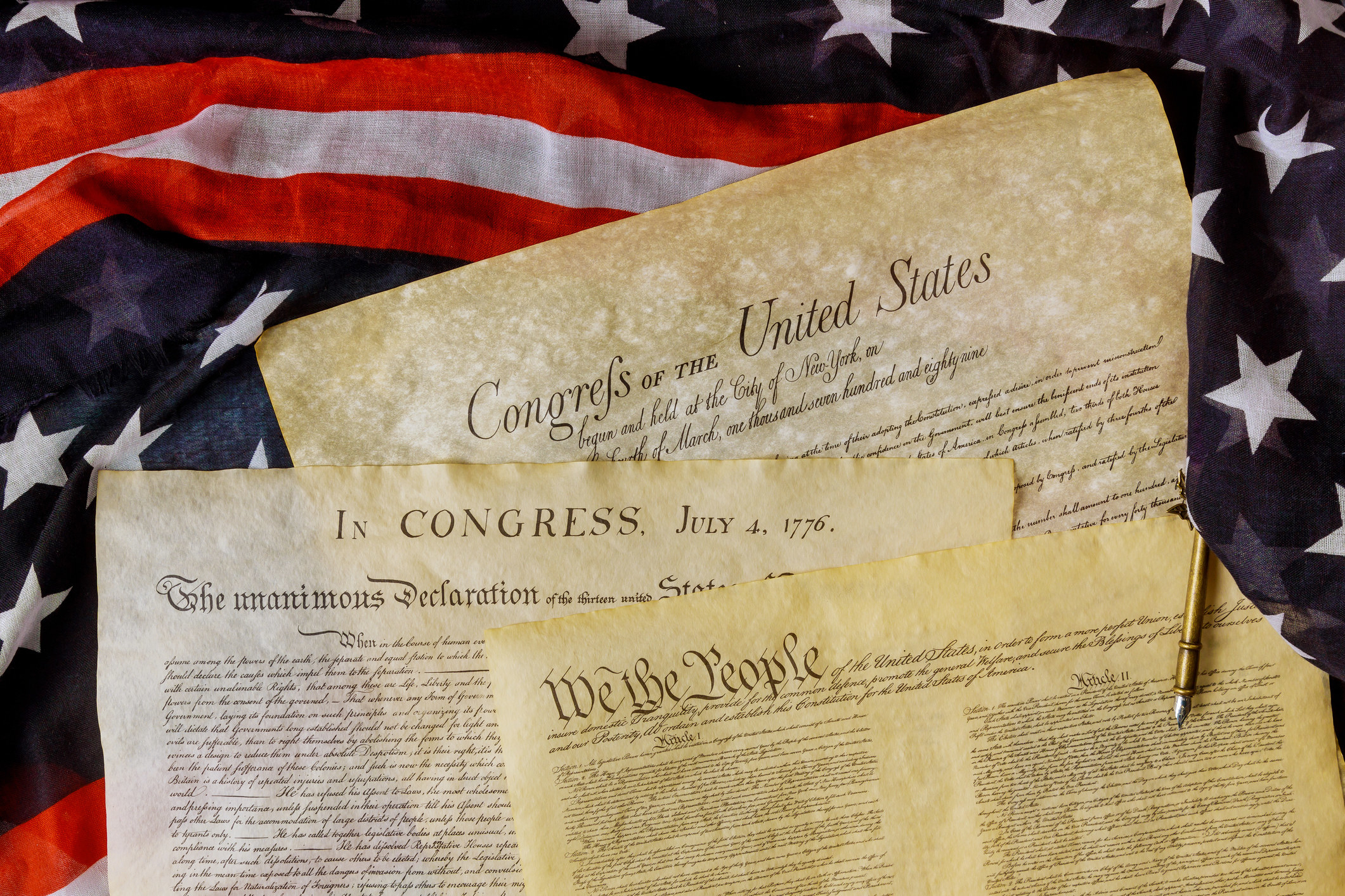 an American flag and federal documents like the US Constitution