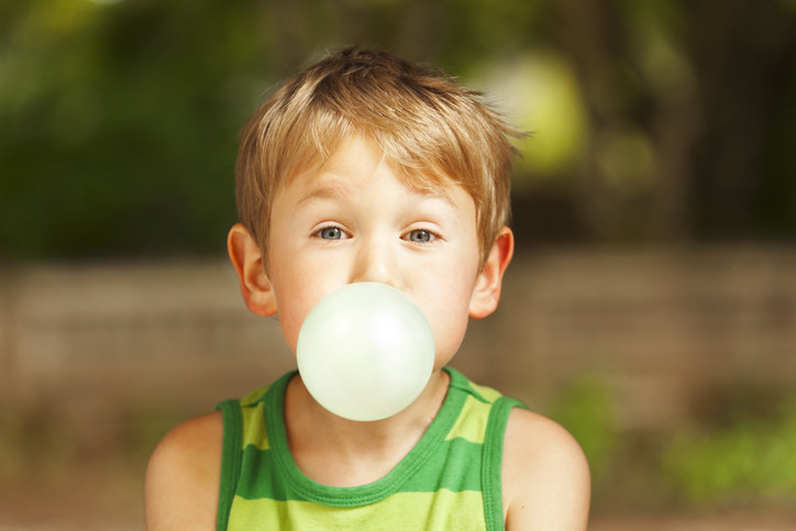 a kid blowing a bubble