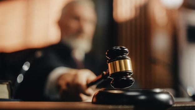 A judge taps a gavel during a court hearing