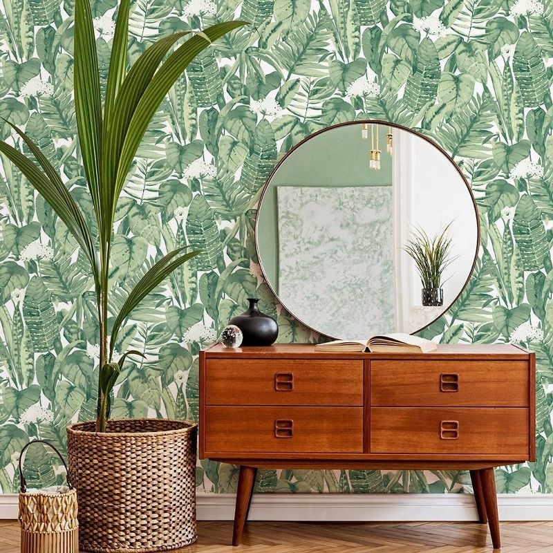 the tropical peel and stick wallpaper with a console table and plant