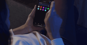 a gif of a person using their smart phone to changing the color of their lights