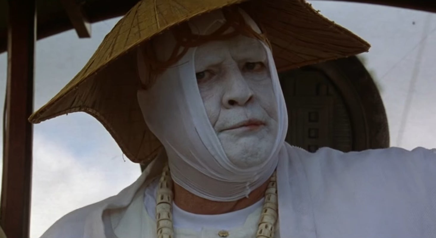 Dr. Moreau wearing a white tunic and matching face paint in &quot;The Island of Dr. Moreau&quot; (1996)