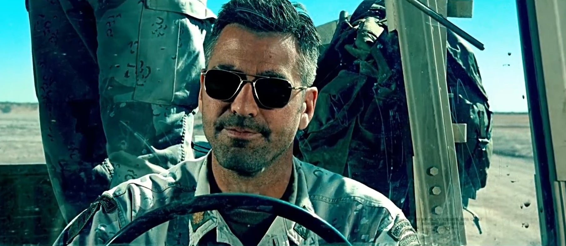 Major Gates sitting in the driver&#x27;s seat of a buggy in &quot;Three Kings&quot;