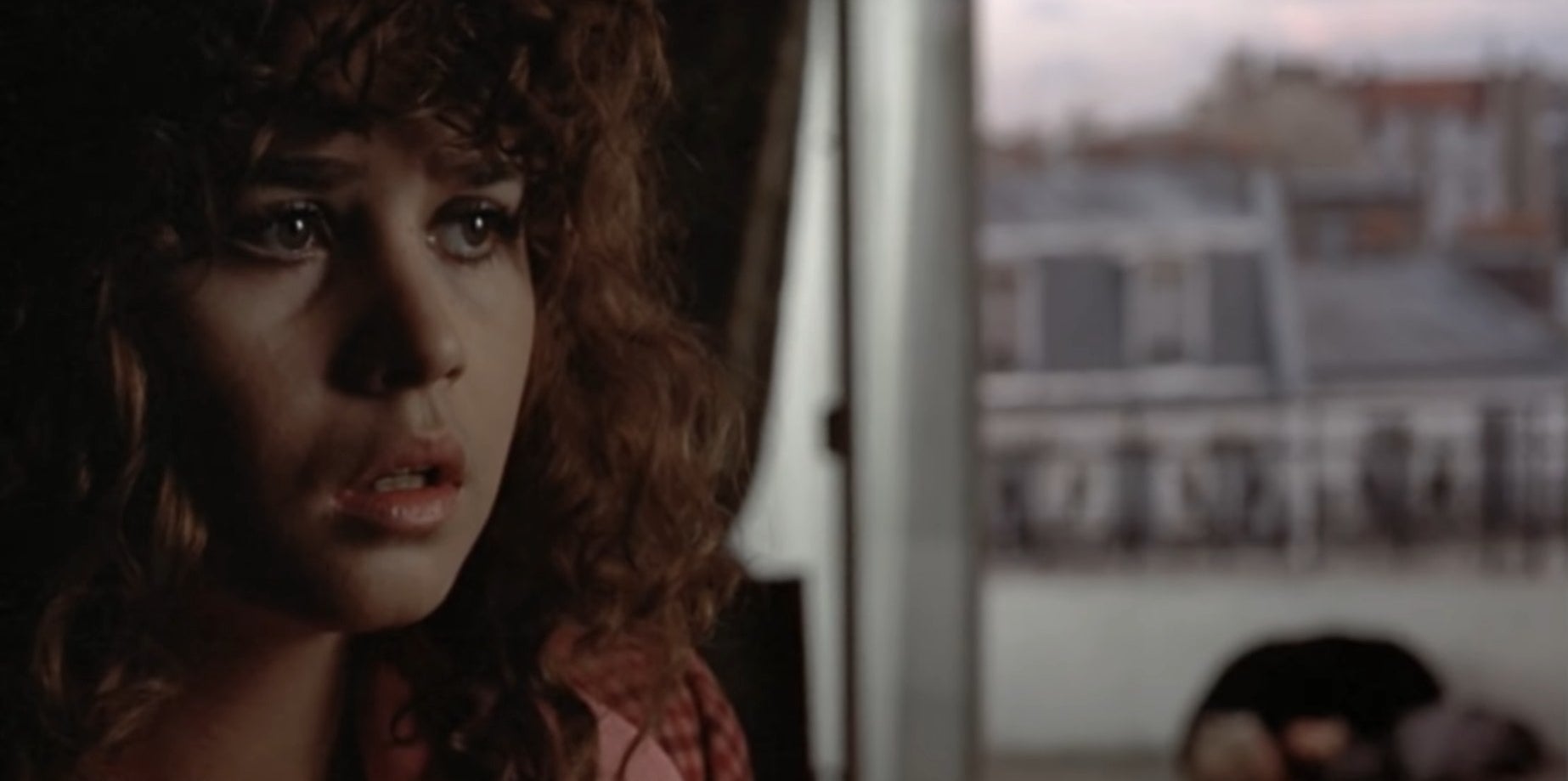 Close-up of Jeanne with Paul&#x27;s dead body in the background in &quot;Last Tango in Paris&quot;
