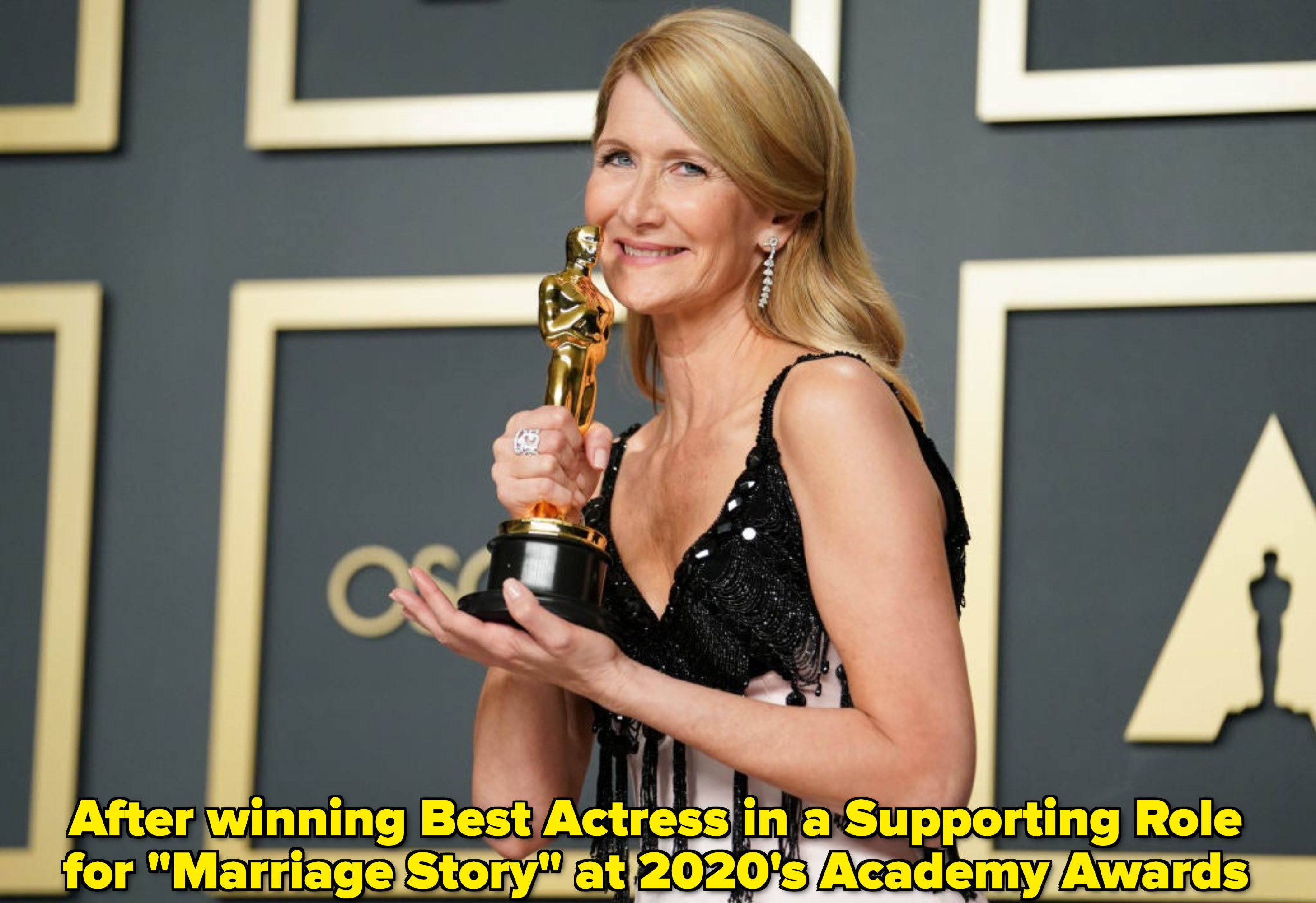 Laura Dern holding an Academy Award and smiling