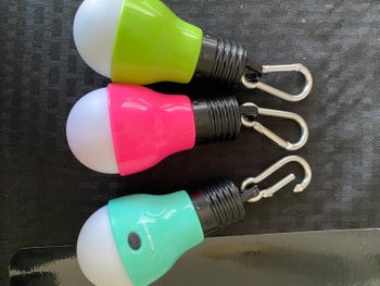 reviewer's photo of three bulbs in bright colors
