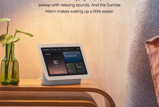 a smart home speaker in white on a nightstand