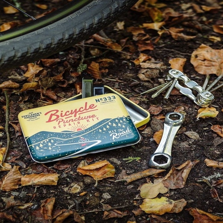 The kit next to a bike in the woods