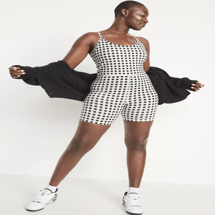 A person wearing the bodysuit with a hoodie and sneakers