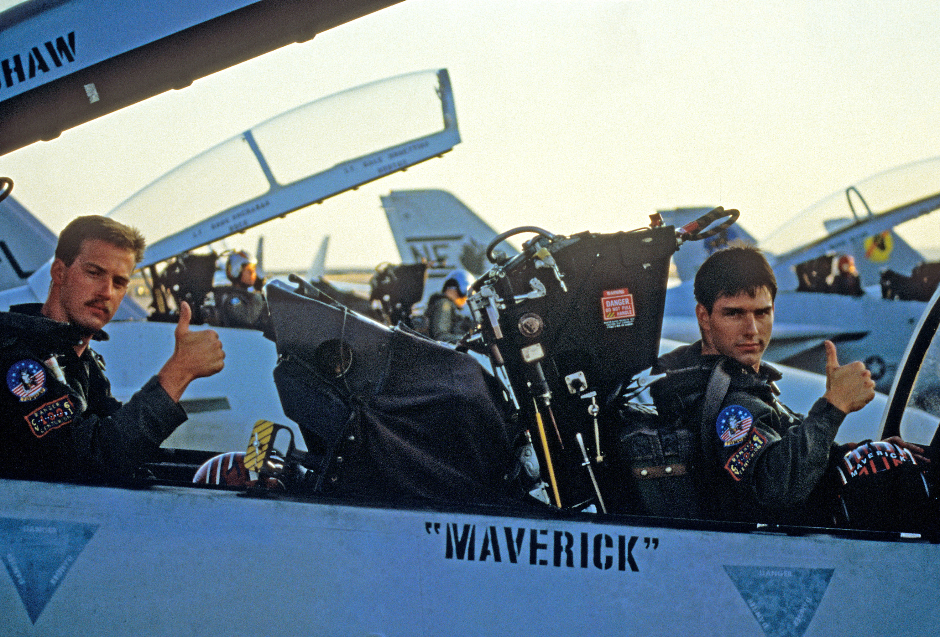 Maverick and Goose give a thumbs up from inside their plane in the original film