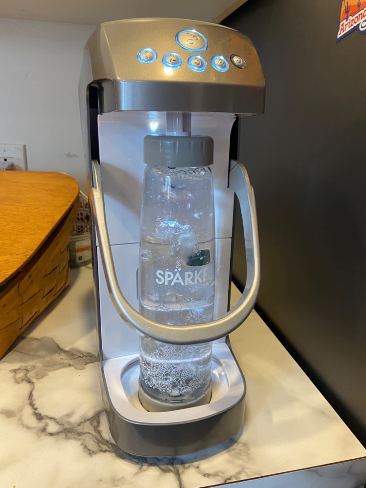 a reviewer photo of the sparkling water maker on the counter