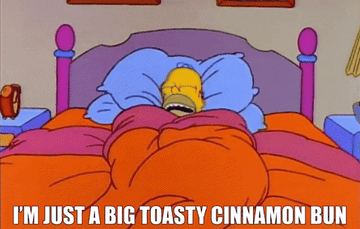 homer simpson snuggled in bed saying i&#x27;m just a big toasty cinnamon bun