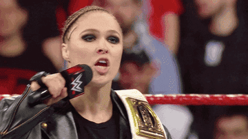 GIF of Ronda Rousey saying &quot;Youre welcome&quot; in a wrestling ring and dropping the mic