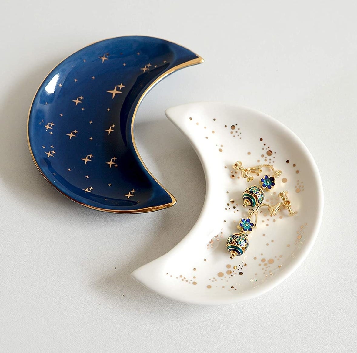 two moon-shaped trinket dishes