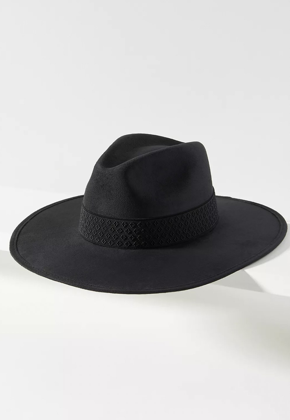 The black suede hat with diamond textured detailing on the brim