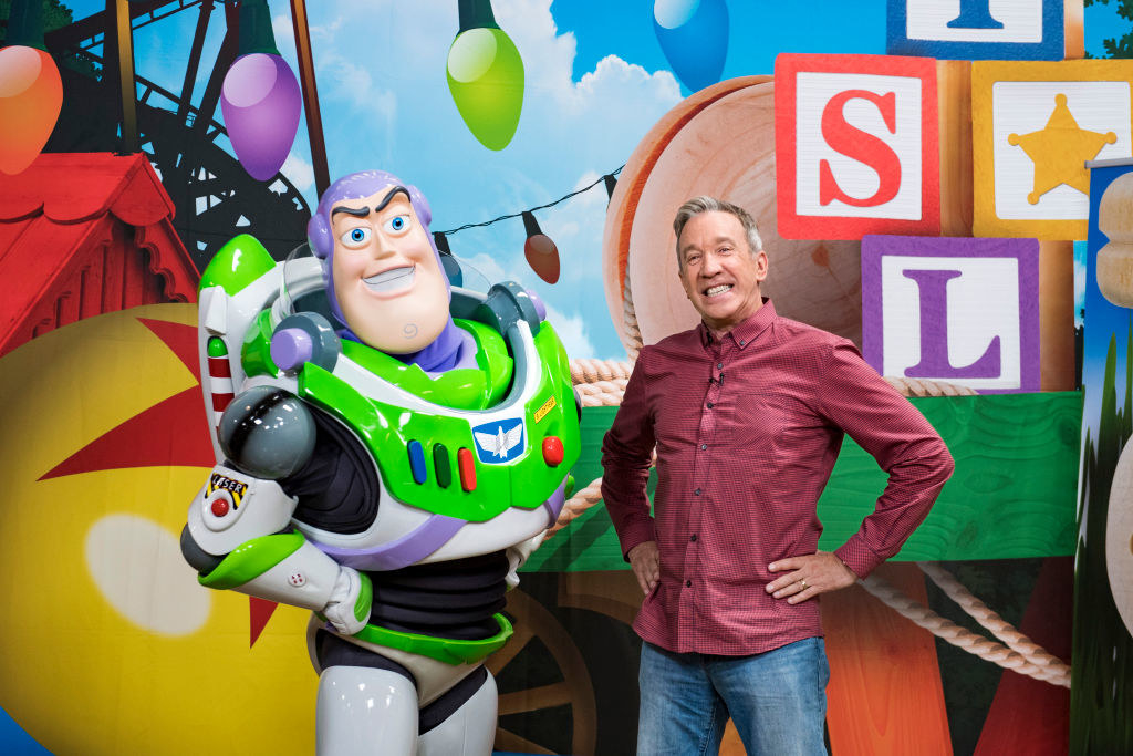 Tim posing with a full-sized version of the Buzz Lightyear he played