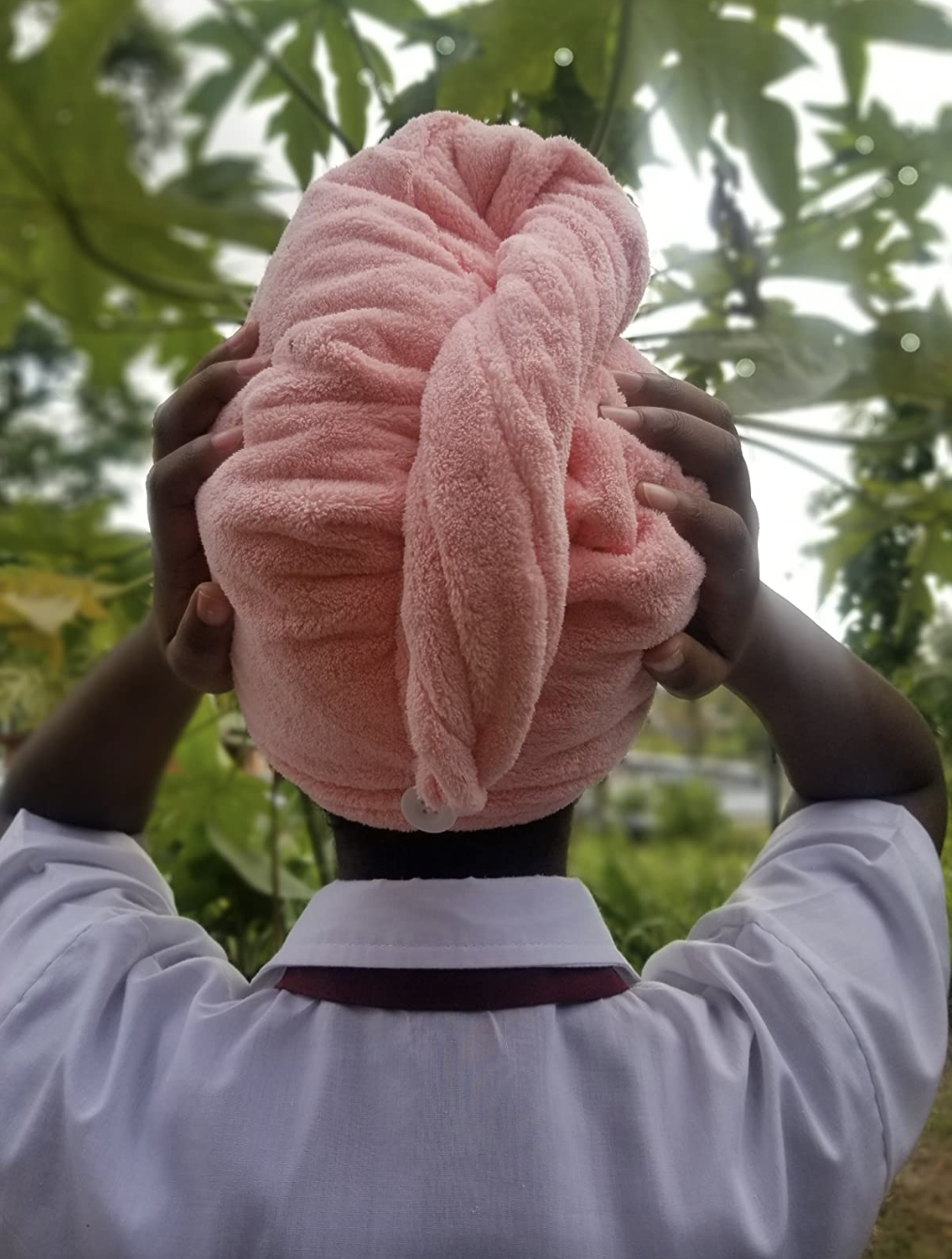 a reviewer photo of a person wearing the pink towel and showing the back