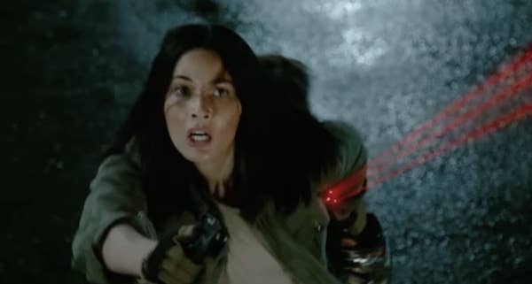 close up of Munn&#x27;s character holding a gun