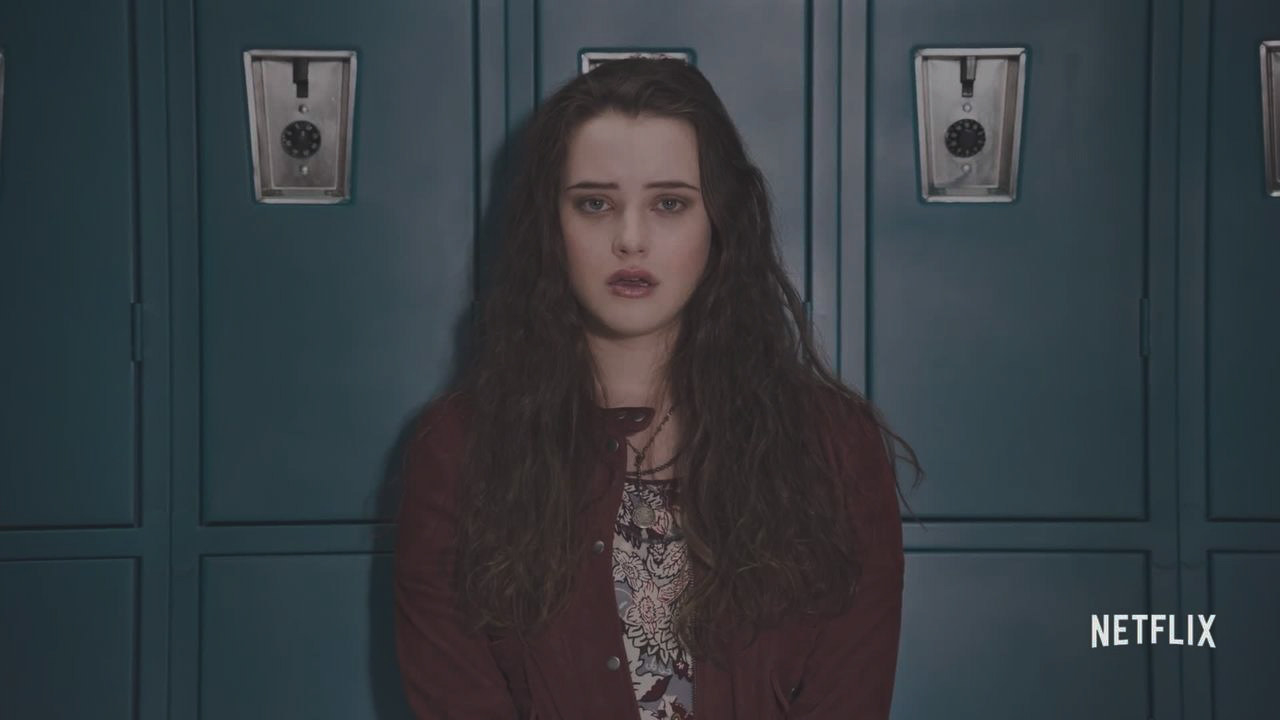 a girl standing in front of lockers