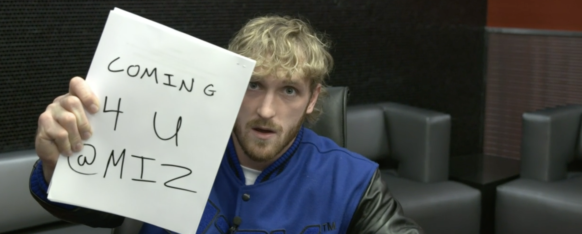 Logan Paul holds a note that says &quot;Coming for you Miz&quot;