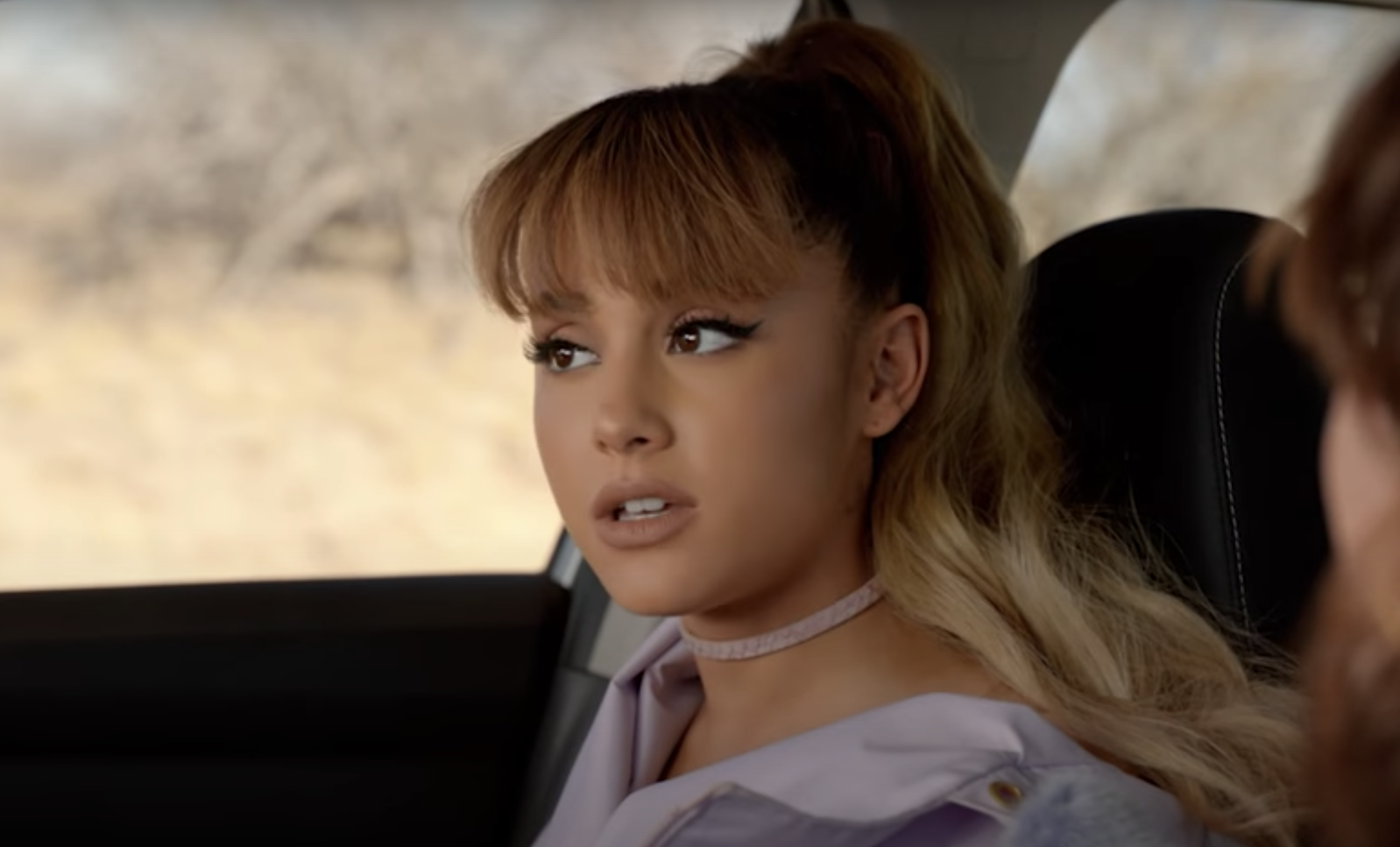 Ariana Grande looking out a car window
