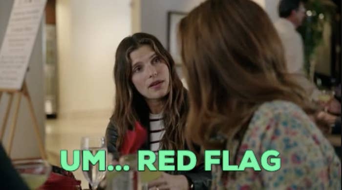 A woman looking at another woman with the words, &quot;um...red flag&quot;